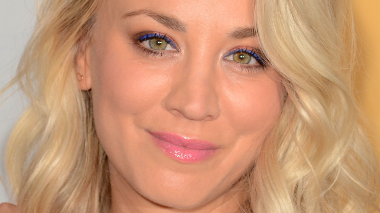 Kaley Cuoco poses in pink lipstick
