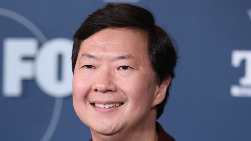 Ken Jeong smiling on the red carpet