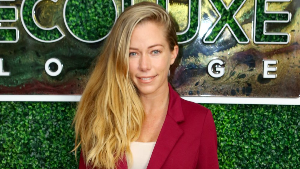 Kendra Wilkinson smiling and posing at an event