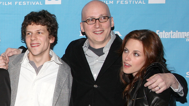 Kristen Stewart and Jesse Eisenberg posing with Greg Mottola