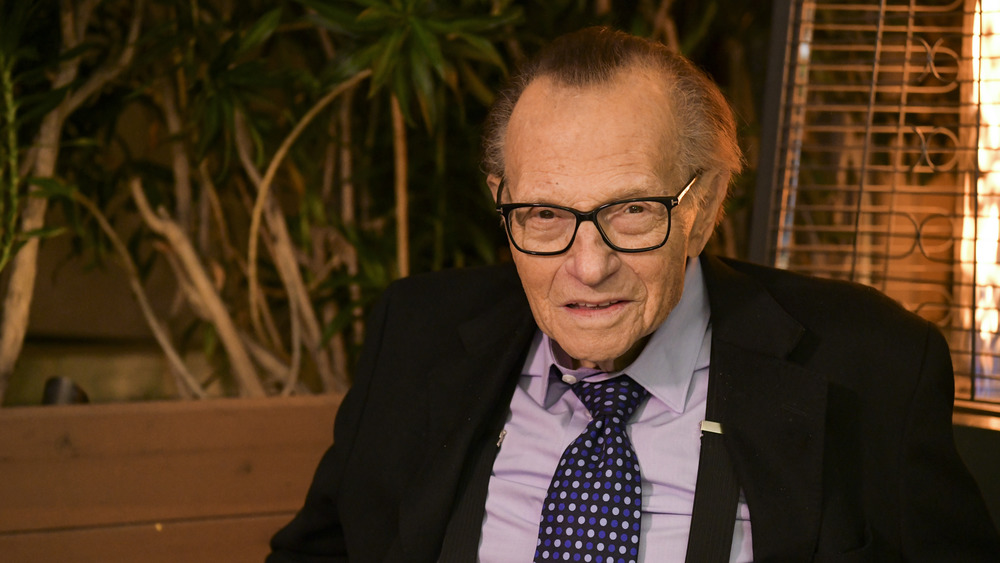 Larry King at a desk