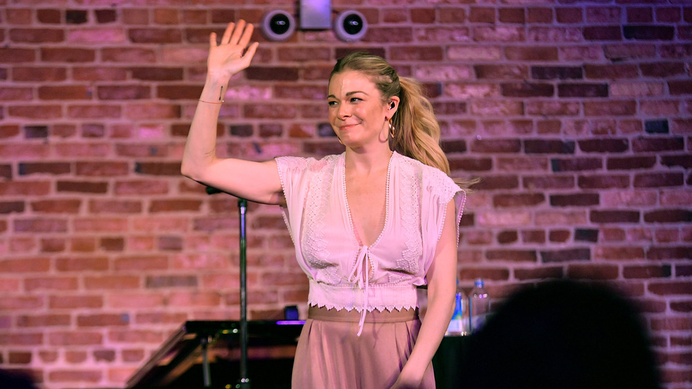 LeAnn Rimes waving on stage