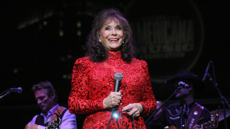 Loretta Lynn holding a microphone