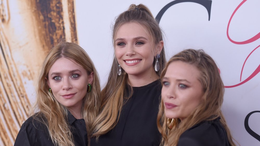 Elizabeth Olsen (center) and Mary-Kate and Ashley Olsen attend the 2016 CFDA Fashion Awards