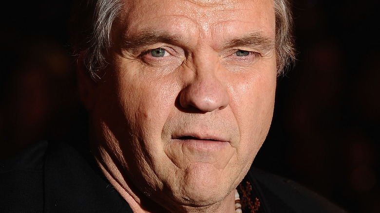 Meat Loaf poses in a black shirt in 2010