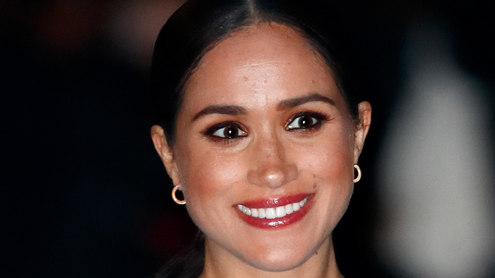 Meghan Markle and Prince Harry walking in the rain