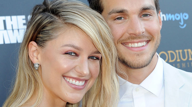 Melissa Benoist and Chris Wood smile together