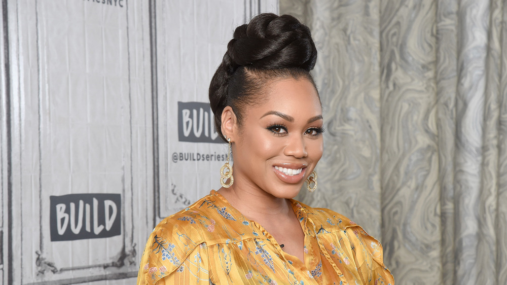 Monique Samuels smiling on a red carpet