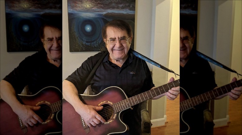 Dr. Now playing a guitar