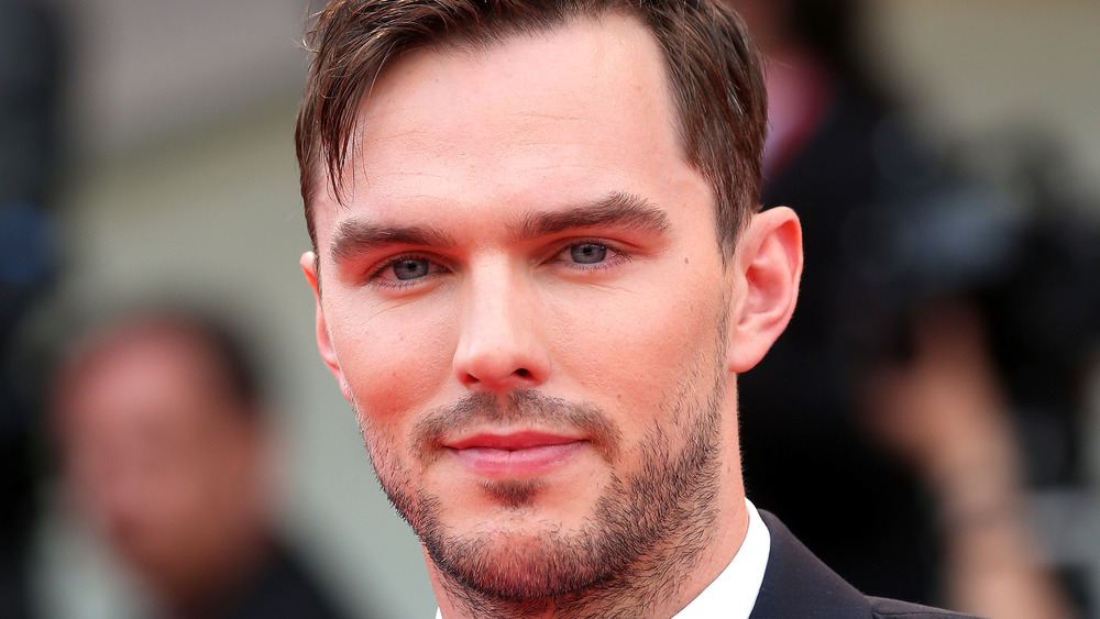 Nicholas Hoult poses at an event