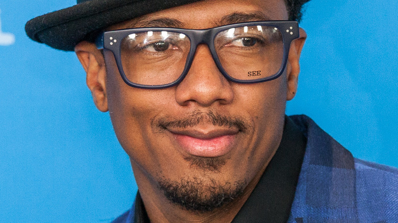 Nick Cannon wearing glasses and hat