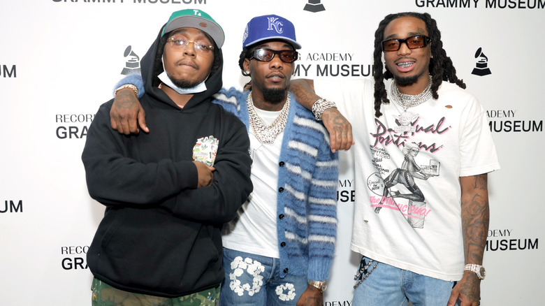 Migos posing on the carpet