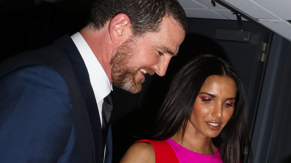 Padma Lakshmi and Adam Dell smiling at a party 