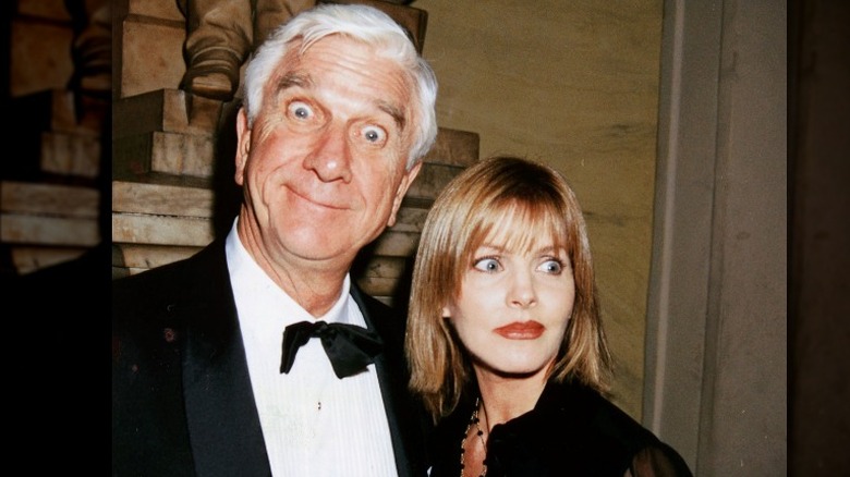 Leslie Nielsen making face beside Priscilla Presley