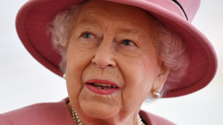 Queen Elizabeth II wears a pink hat