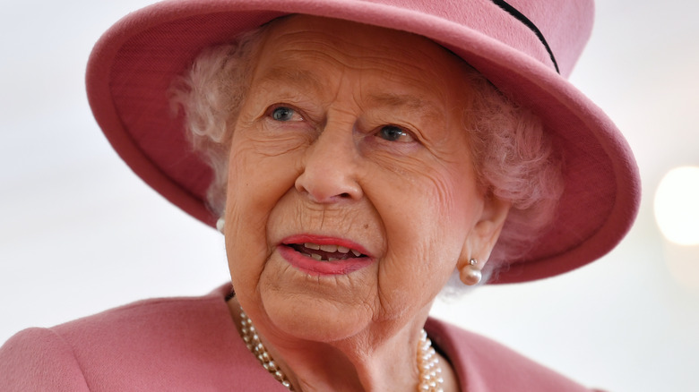 Queen Elizabeth reacts to something at an event