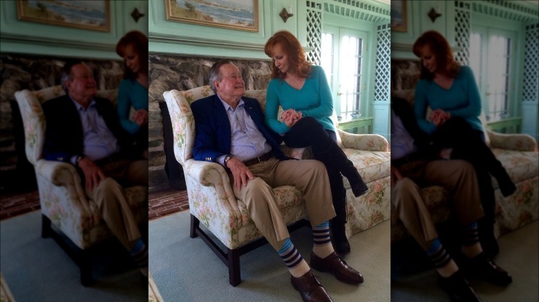 Reba McEntire holds George H.W. Bush's hand