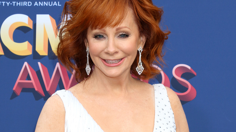 Reba McEntire dangly earrings white dress