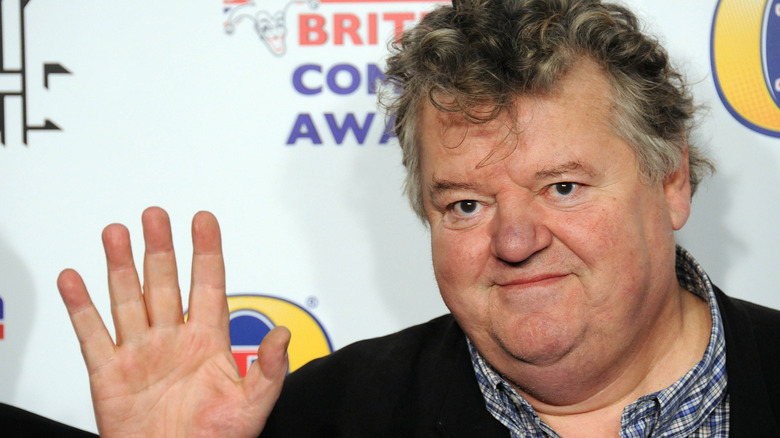 Robbie Coltrane waves hello at the British comedy awards
