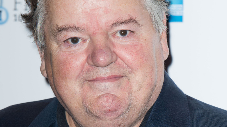 Robbie Coltrane posing on red carpet