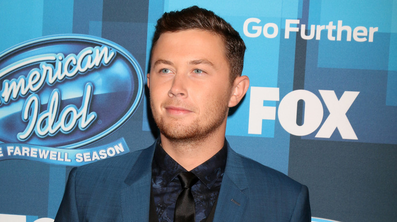 Scotty McCreery looking thoughtful at an event