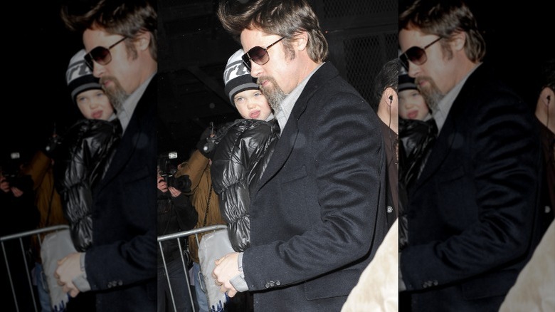 Shiloh Jolie-Pitt and Brad Pitt walking