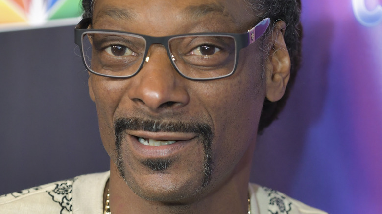 Snoop Dogg diamond rim glasses yellow jacket