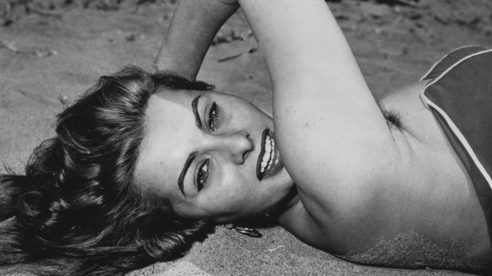 Sophia Loren lying on the beach in 1954