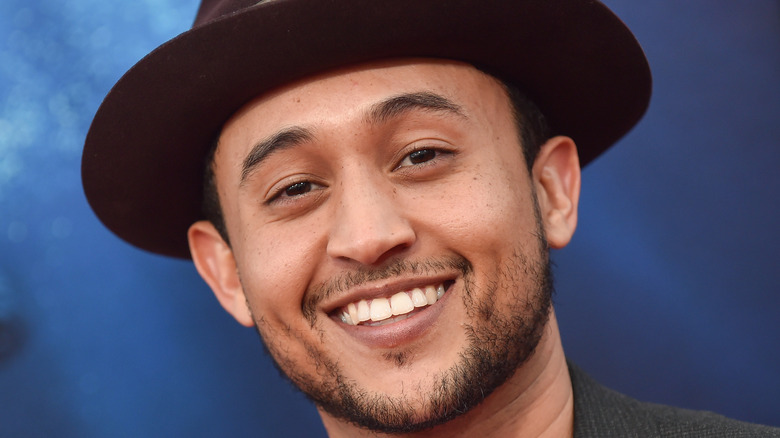 Tahj Mowry smiles at camera