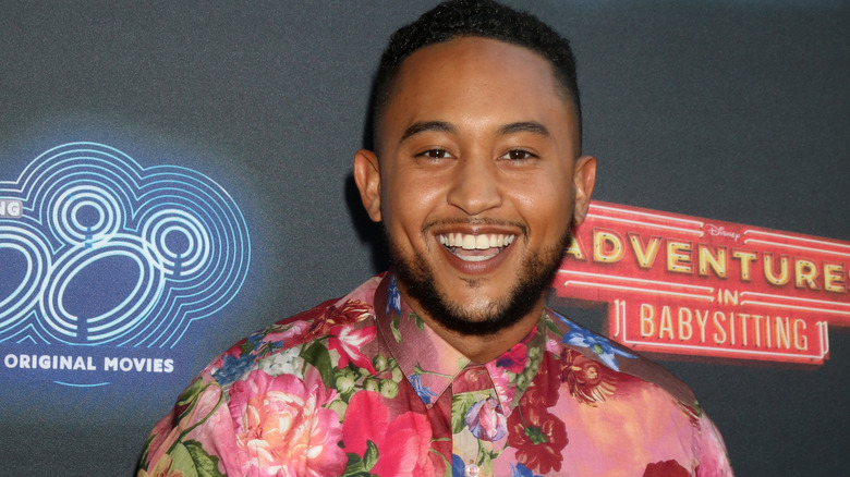 Tahj Mowry smiles at camera