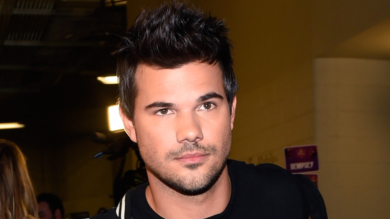 Taylor Lautner walking in black