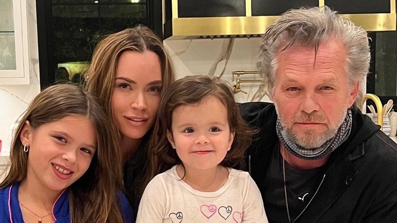 Teddi and John Mellencamp smiling with kids
