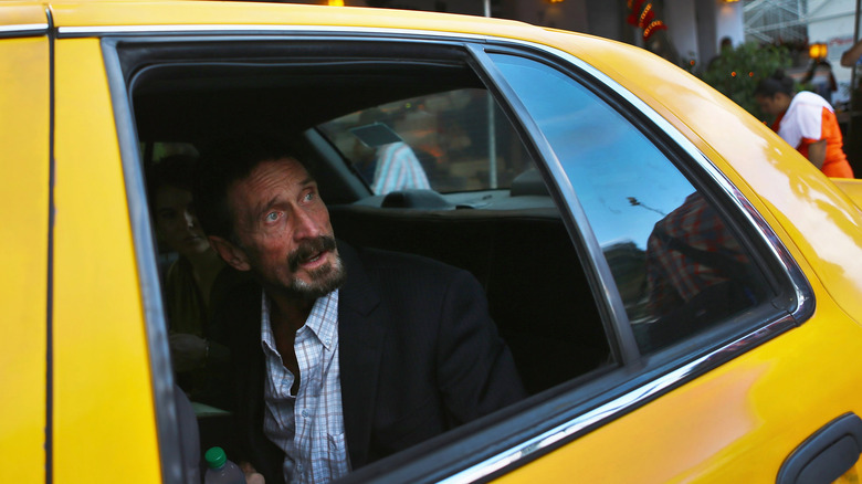 John McAfee in yellow taxi