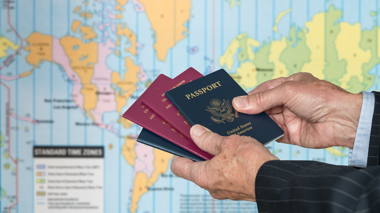 Hands holding UK and USA passports