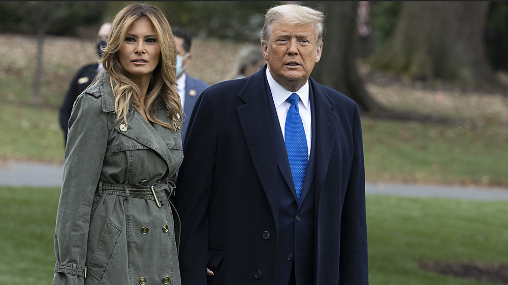 Melania Trump and Donald Trump walking outside