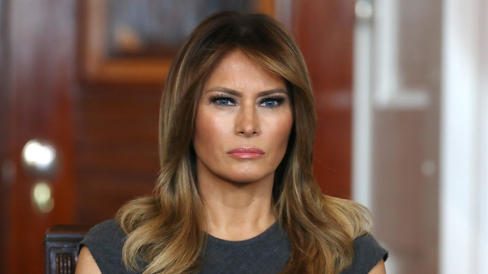 Melania Trump seated and looking at camera