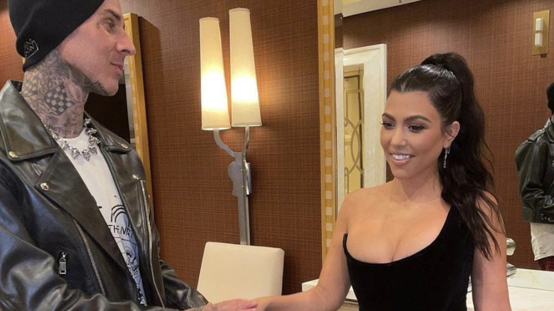 Travis Barker, Kourtney Kardashian, smiling