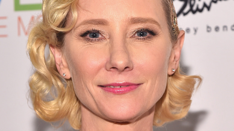 Anne Heche smiling with pink lipstick