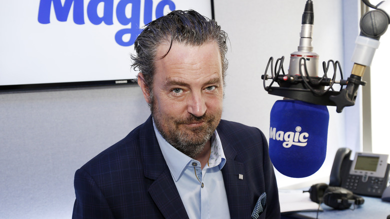 Matthew Perry in front of a mic
