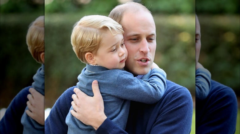 Prince William holding Prince George