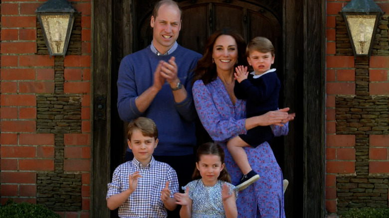 The Wales family posing outside their home