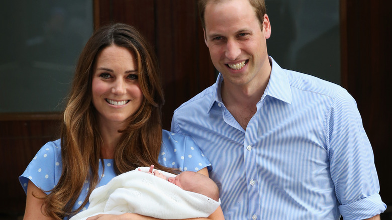 Kate Middleton and Prince William holding baby Prince George