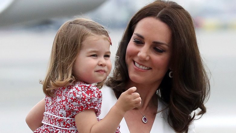 Kate Middleton holding Princess Charlotte 