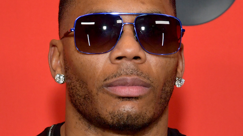 Nelly posing in sunglasses