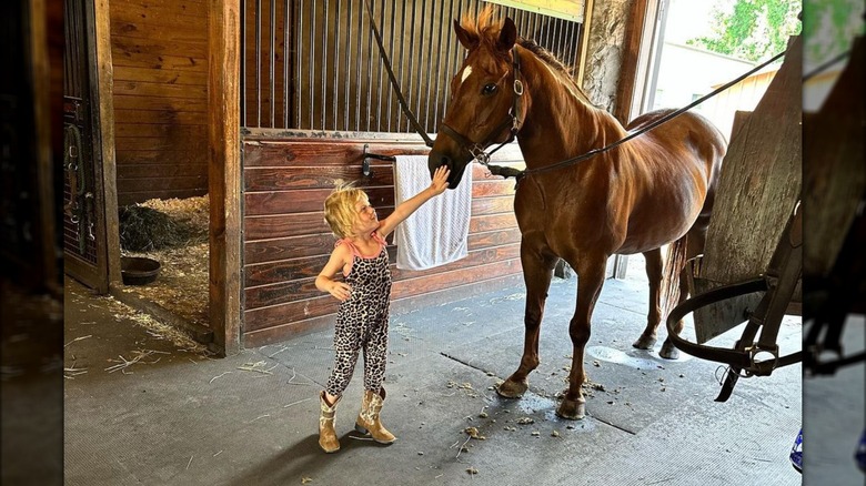 Carolina Trump petting horse's nose