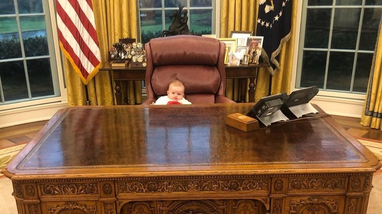 Carolina Trump seated at Resolute Desk