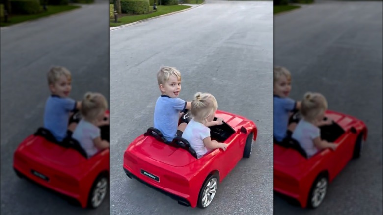 Luke, Carolina Trump in red ride-on car