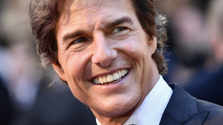 Tom Cruise smiling widly showing white teeth