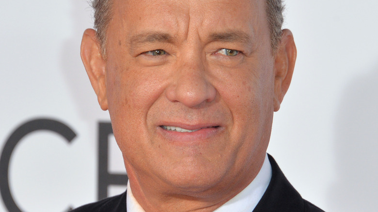 Tom Hanks smiles on red carpet
