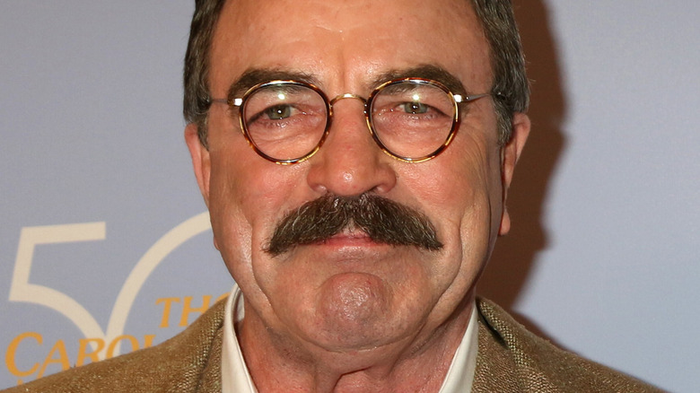 Tom Selleck with slight smile looking at the camera